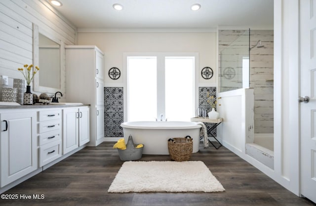 bathroom with hardwood / wood-style floors, separate shower and tub, and vanity