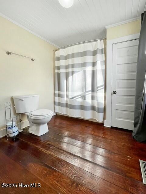 bathroom featuring toilet, crown molding, and wood-type flooring