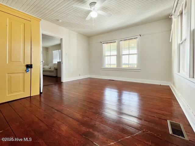 unfurnished room featuring ceiling fan and dark hardwood / wood-style floors