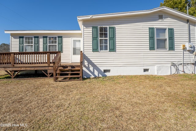 back of house with a wooden deck and a yard