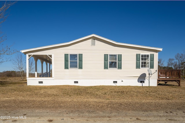 view of side of home with a lawn and a sunroom