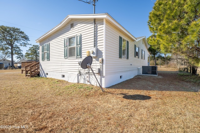 view of property exterior with a yard and central air condition unit