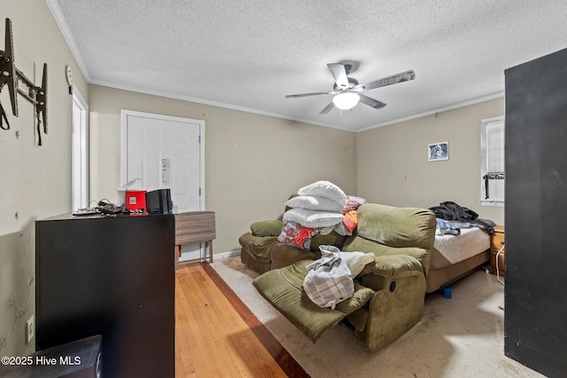 bedroom featuring crown molding, ceiling fan, wood-type flooring, and a textured ceiling