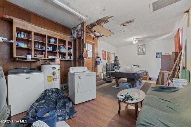 interior space featuring hardwood / wood-style floors, washer / dryer, water heater, and a textured ceiling