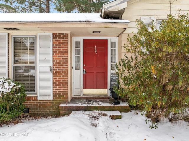 view of snow covered property entrance