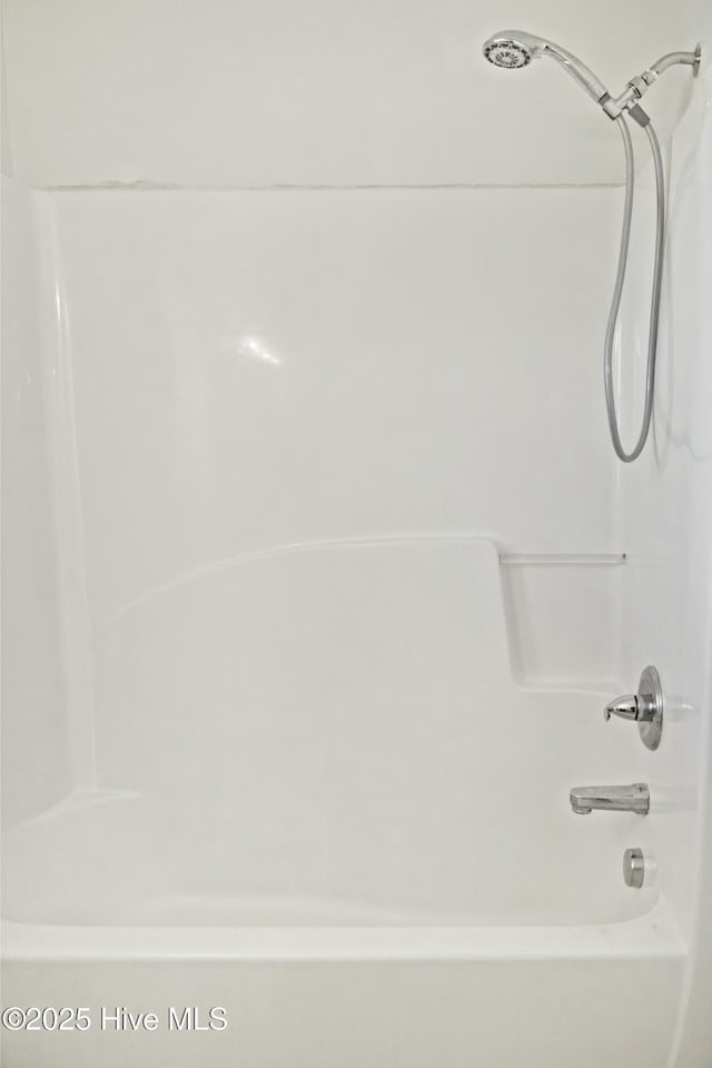 bathroom with washtub / shower combination