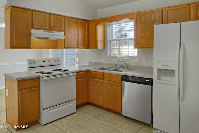 kitchen featuring sink, white appliances, and light tile patterned floors