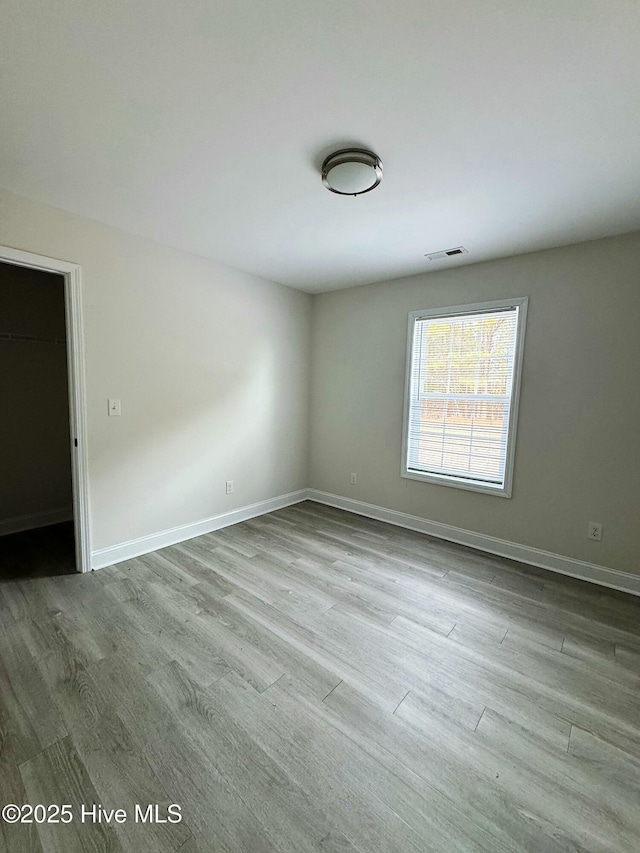 spare room with light wood-type flooring