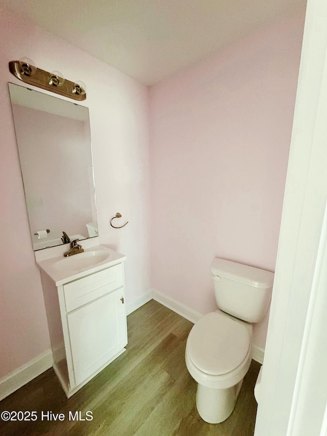 bathroom featuring hardwood / wood-style floors, toilet, and vanity