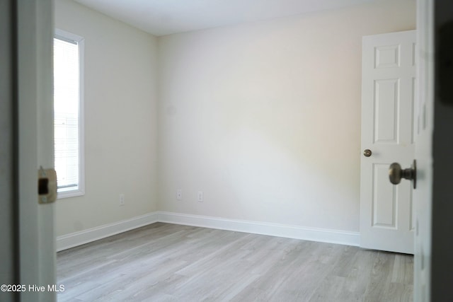 empty room with light hardwood / wood-style flooring