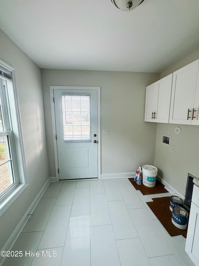 laundry room with hookup for a washing machine and cabinets