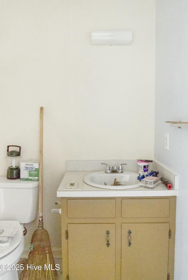 bathroom featuring vanity and toilet