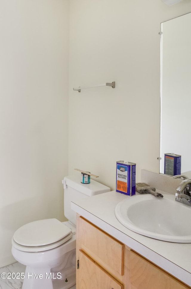 bathroom with vanity, tile patterned floors, and toilet