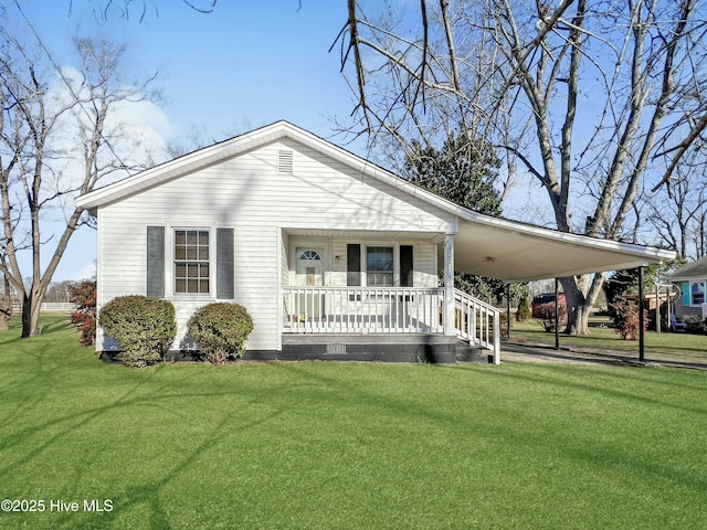 view of front of house with a front yard, a carport, and covered porch