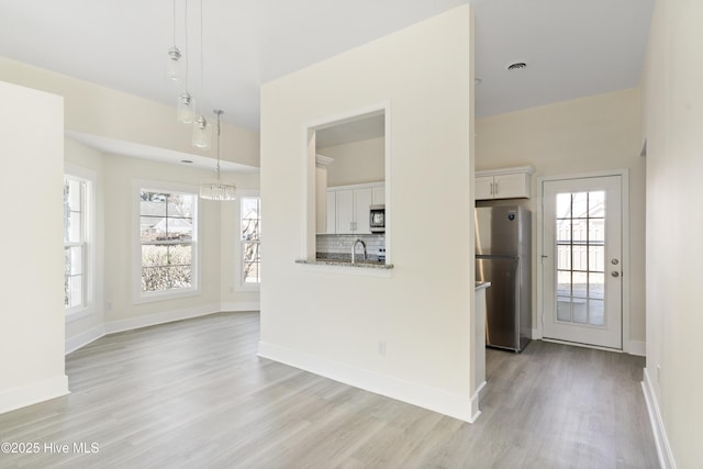 interior space with sink and light hardwood / wood-style flooring