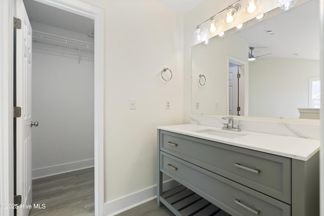 bathroom featuring vanity, wood-type flooring, and ceiling fan