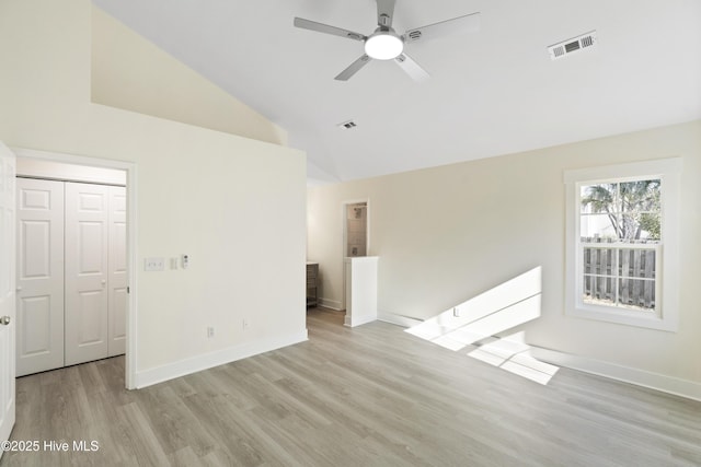 empty room featuring ceiling fan, high vaulted ceiling, and light wood-type flooring