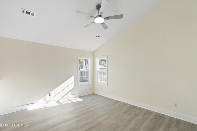 empty room featuring ceiling fan, high vaulted ceiling, and light hardwood / wood-style floors