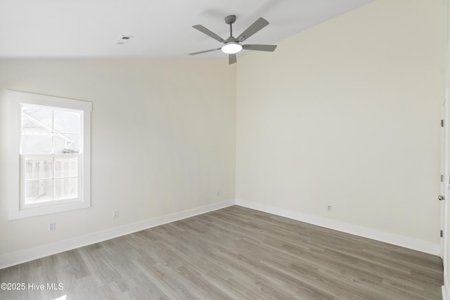 spare room with wood-type flooring and ceiling fan