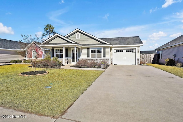 craftsman-style home featuring a garage, covered porch, and a front lawn