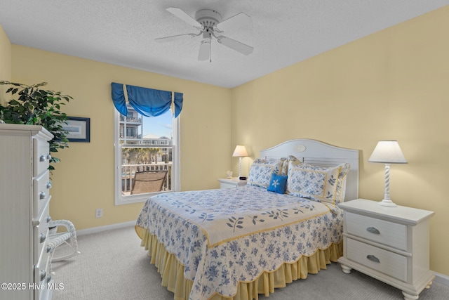 bedroom with light carpet, a textured ceiling, and ceiling fan