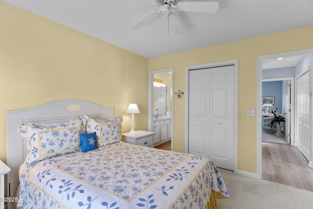 carpeted bedroom featuring ceiling fan, connected bathroom, and a closet