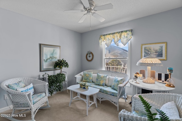 carpeted living room with a textured ceiling and ceiling fan