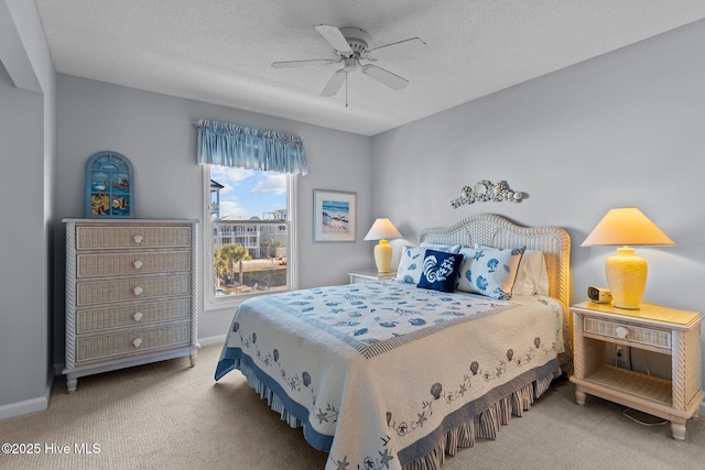 bedroom featuring ceiling fan, a textured ceiling, and carpet floors