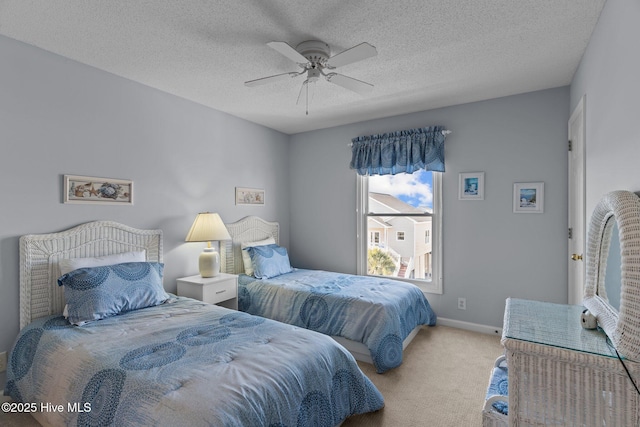 carpeted bedroom with ceiling fan and a textured ceiling