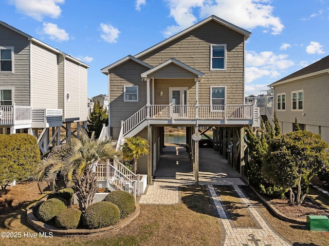 beach home featuring a carport and stairway