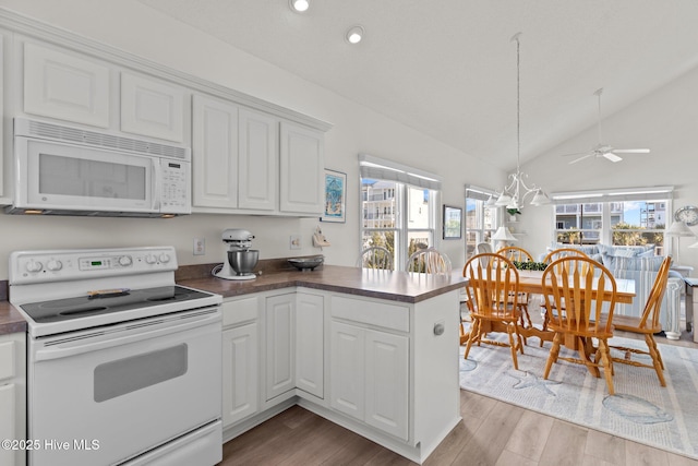 kitchen featuring light hardwood / wood-style floors, white appliances, white cabinets, and kitchen peninsula