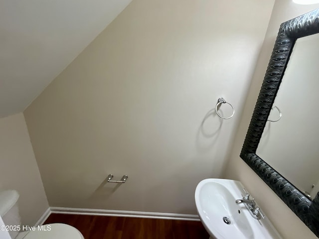 bathroom featuring toilet, hardwood / wood-style flooring, and sink