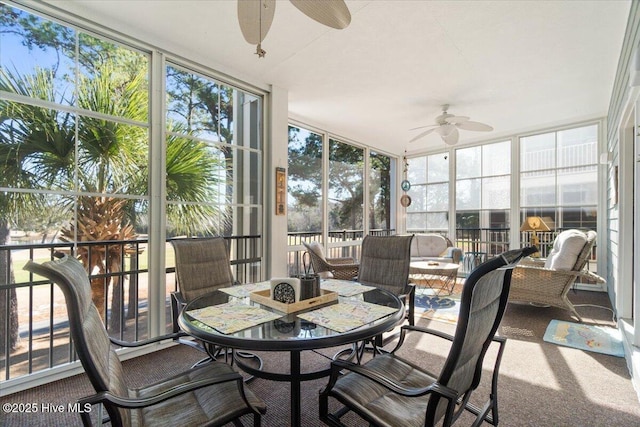 sunroom featuring ceiling fan