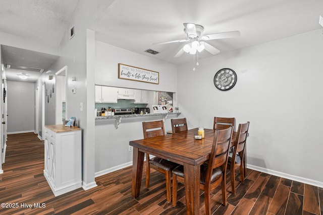 dining area featuring dark wood-type flooring and ceiling fan