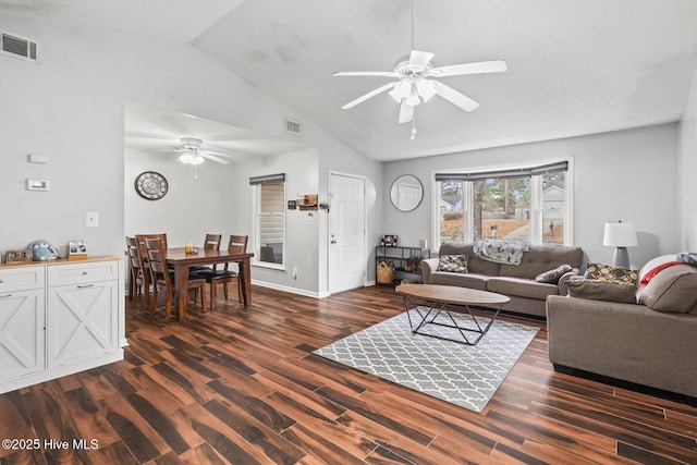 living room featuring vaulted ceiling, ceiling fan, and dark hardwood / wood-style flooring