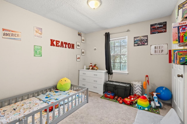 carpeted bedroom featuring a textured ceiling