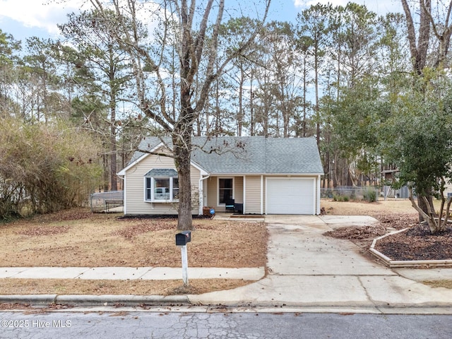 view of front of property with driveway, a shingled roof, and an attached garage