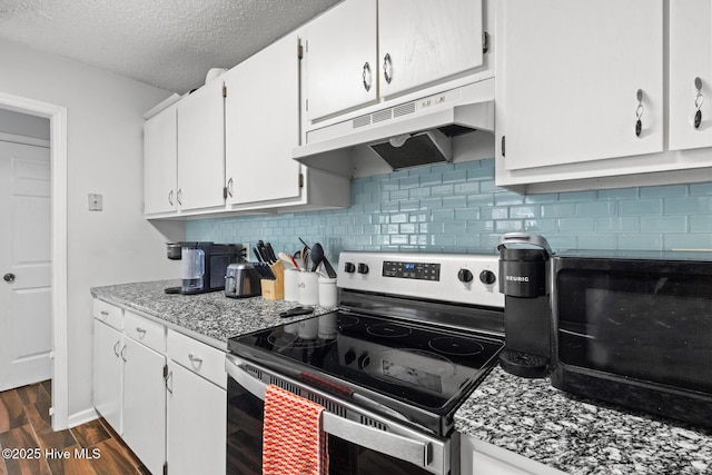 kitchen featuring under cabinet range hood, white cabinets, stainless steel range with electric cooktop, light countertops, and dark wood-style floors