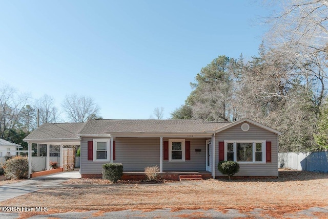 ranch-style home featuring a carport