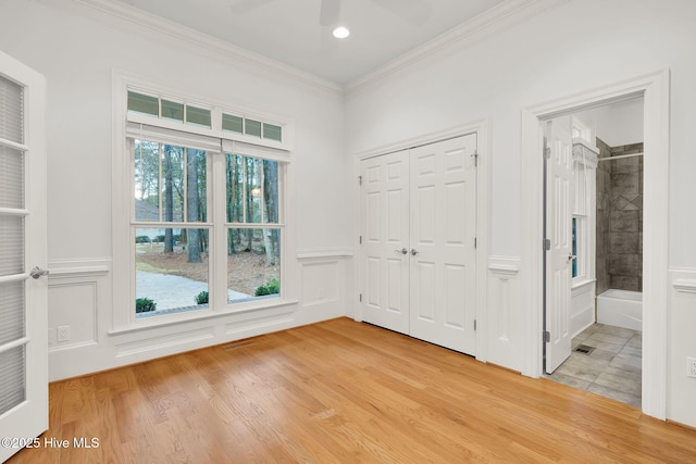 interior space with crown molding and light wood-type flooring