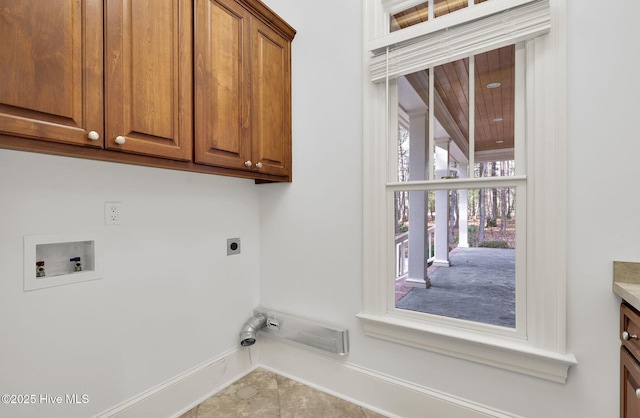 laundry room with electric dryer hookup, washer hookup, cabinets, and light tile patterned flooring