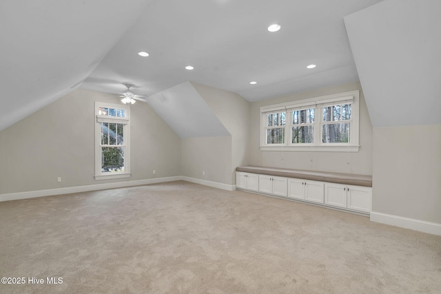 bonus room featuring vaulted ceiling and light carpet