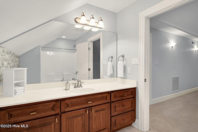 bathroom featuring vanity and vaulted ceiling