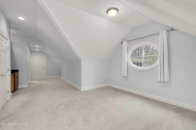 bonus room featuring vaulted ceiling and light carpet