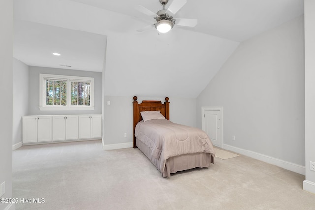 bedroom with ceiling fan, lofted ceiling, and light colored carpet