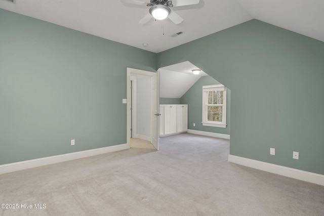 bonus room featuring vaulted ceiling, light colored carpet, and ceiling fan