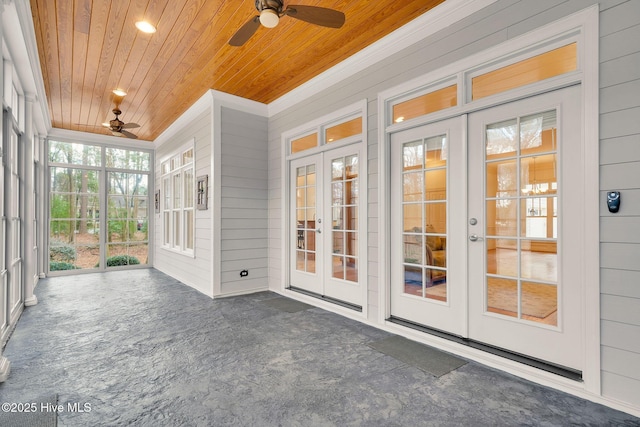 unfurnished sunroom featuring french doors, ceiling fan, and wooden ceiling