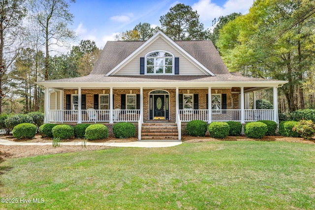 farmhouse inspired home with a front yard and a porch