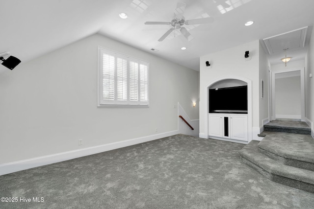 unfurnished living room featuring ceiling fan, lofted ceiling, and dark colored carpet