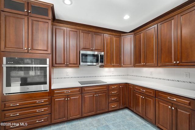 kitchen featuring stainless steel appliances and decorative backsplash